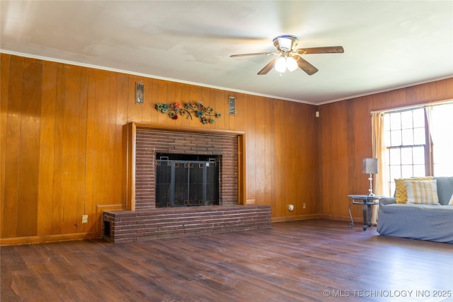 519 N 15th St, Muskogee, OK 74401 - unfurnished living room featuring ceiling fan, wood finished floors, a brick fireplace, wood walls, and ornamental molding