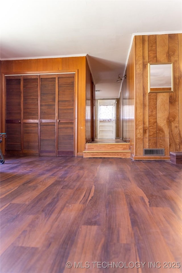 519 N 15th St, Muskogee, OK 74401 - unfurnished living room with wood walls, wood finished floors, and ornamental molding