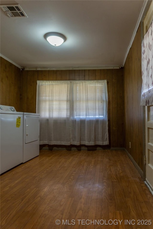 519 N 15th St, Muskogee, OK 74401 - laundry area featuring washing machine and clothes dryer, wood finished floors, wooden walls, and ornamental molding