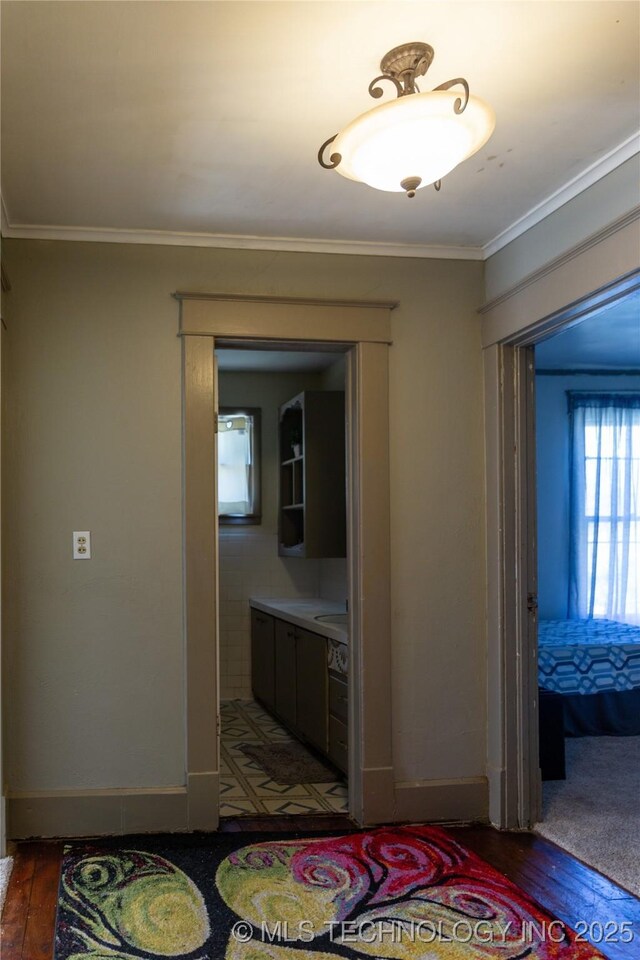 519 N 15th St, Muskogee, OK 74401 - hallway with ornamental molding and wood finished floors