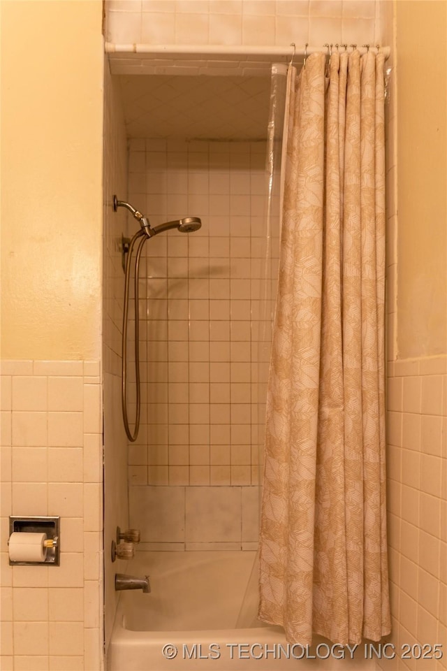 519 N 15th St, Muskogee, OK 74401 - bathroom with tile walls, shower / bath combo with shower curtain, and wainscoting