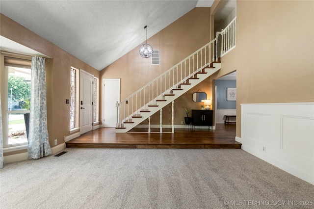 4305 E 82nd St, Tulsa, OK 74137 - carpeted entryway featuring stairs, high vaulted ceiling, and a chandelier