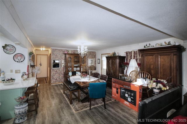 638 W Main St, Caney, OK 74533 - dining room featuring a chandelier, dark wood-style floors, ornamental molding, and wallpapered walls