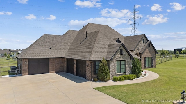 7003 E 88th St N, Owasso, OK 74055 - view of front of house with concrete driveway, an attached garage, brick siding, roof with shingles, and stone siding