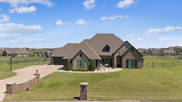 7003 E 88th St N, Owasso, OK 74055 - french country home featuring concrete driveway, brick siding, stone siding, an attached garage, and a residential view