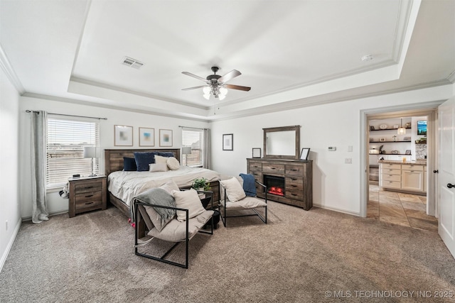 7003 E 88th St N, Owasso, OK 74055 - bedroom with a tray ceiling, light carpet, crown molding, a fireplace, and ceiling fan