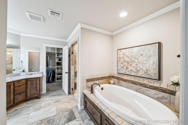 7003 E 88th St N, Owasso, OK 74055 - full bathroom with vanity, a bath, crown molding, a walk in closet, and recessed lighting