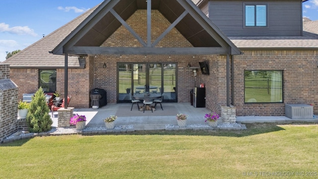 7003 E 88th St N, Owasso, OK 74055 - rear view of property with brick siding, a yard, a shingled roof, and a patio area