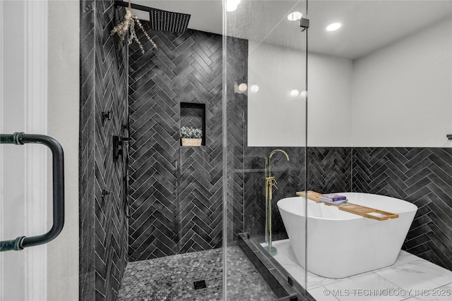 14900 E 88th St N, Owasso, OK 74055 - full bath featuring a soaking tub, a stall shower, marble finish floors, wainscoting, and tile walls
