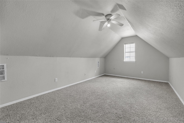 14900 E 88th St N, Owasso, OK 74055 - additional living space with a textured ceiling, a ceiling fan, vaulted ceiling, and carpet floors