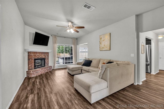 14900 E 88th St N, Owasso, OK 74055 - living room with dark wood-style flooring, ceiling fan, and a fireplace