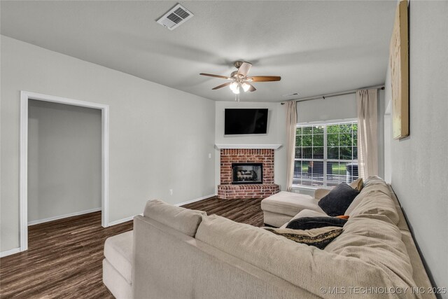 14900 E 88th St N, Owasso, OK 74055 - living room with a ceiling fan, dark wood-type flooring, and a brick fireplace