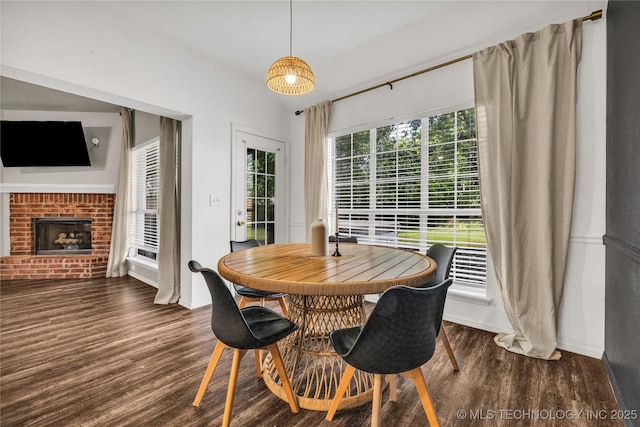 14900 E 88th St N, Owasso, OK 74055 - dining space featuring wood finished floors and a brick fireplace