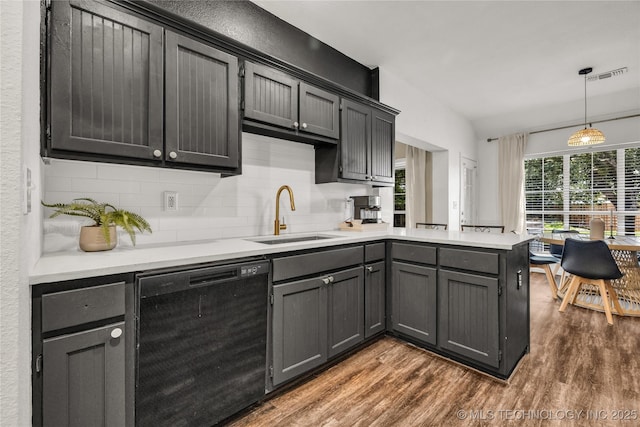 14900 E 88th St N, Owasso, OK 74055 - kitchen with dishwasher, dark wood-style flooring, a peninsula, and tasteful backsplash