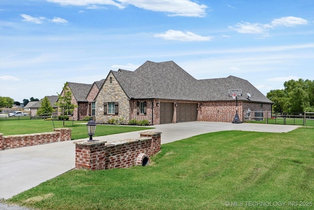 10611 N 159th E Ave, Owasso, OK 74055 - french provincial home featuring concrete driveway, a garage, stone siding, brick siding, and a shingled roof