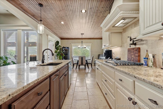 10611 N 159th E Ave, Owasso, OK 74055 - kitchen featuring stainless steel appliances, extractor fan, decorative backsplash, stone tile floors, and light stone countertops