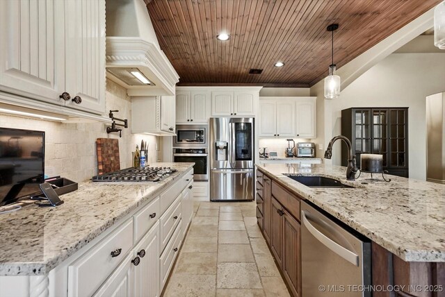 10611 N 159th E Ave, Owasso, OK 74055 - kitchen with stainless steel appliances, custom exhaust hood, wooden ceiling, backsplash, and white cabinetry