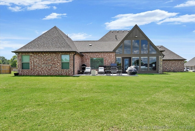 10611 N 159th E Ave, Owasso, OK 74055 - back of house featuring roof with shingles, a patio area, a yard, and brick siding