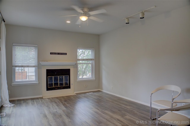 1420 S Frisco Ave Unit 6, Tulsa, OK 74119 - unfurnished living room featuring healthy amount of natural light, a ceiling fan, track lighting, and wood finished floors