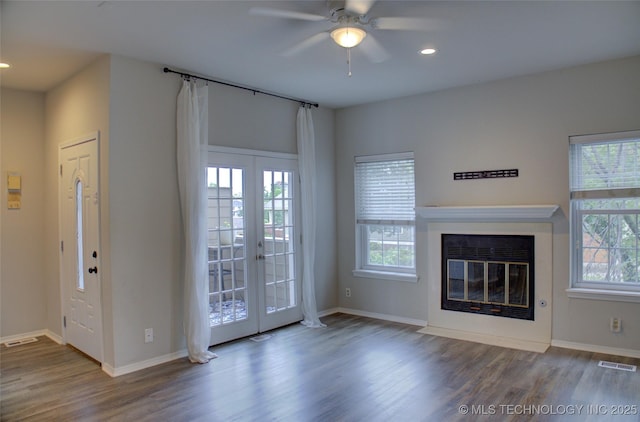 1420 S Frisco Ave Unit 6, Tulsa, OK 74119 - unfurnished living room featuring wood finished floors, french doors, a ceiling fan, recessed lighting, and a fireplace with flush hearth
