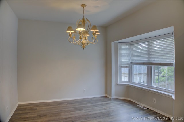 1420 S Frisco Ave Unit 6, Tulsa, OK 74119 - unfurnished room with a chandelier and wood finished floors