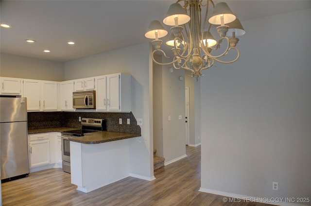 1420 S Frisco Ave Unit 6, Tulsa, OK 74119 - kitchen featuring stainless steel appliances, dark countertops, tasteful backsplash, white cabinetry, and light wood-style floors