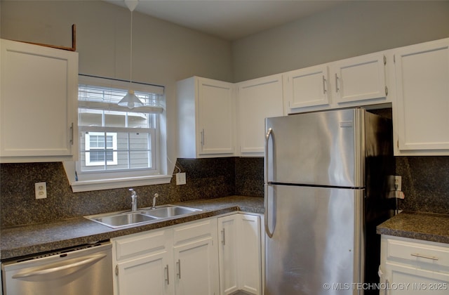 1420 S Frisco Ave Unit 6, Tulsa, OK 74119 - kitchen with stainless steel appliances, dark countertops, white cabinets, and tasteful backsplash