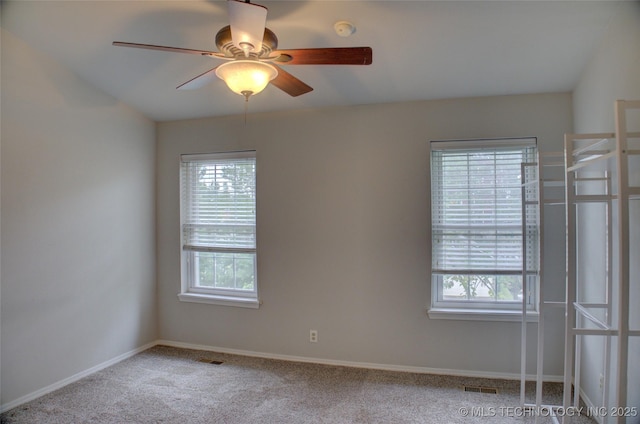 1420 S Frisco Ave Unit 6, Tulsa, OK 74119 - carpeted empty room with healthy amount of natural light, a smoke detector, and a ceiling fan