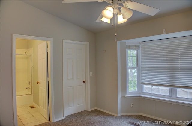 1420 S Frisco Ave Unit 6, Tulsa, OK 74119 - unfurnished bedroom with lofted ceiling, connected bathroom, light carpet, and ceiling fan