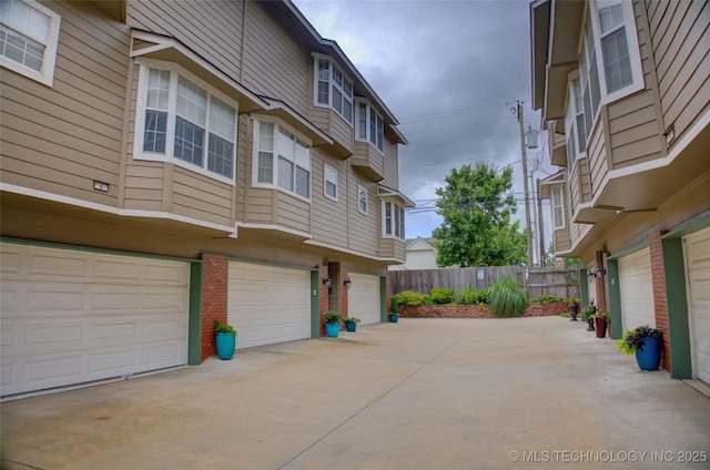 1420 S Frisco Ave Unit 6, Tulsa, OK 74119 - view of side of property featuring an attached garage, brick siding, and driveway