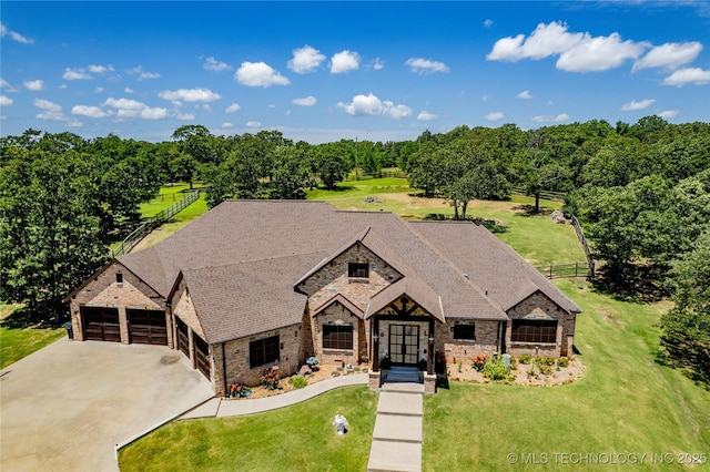13380 S Garrett St, Sapulpa, OK 74066 - view of front facade with stone siding, driveway, an attached garage, and roof with shingles