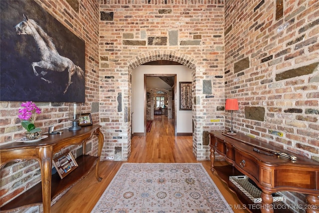 13380 S Garrett St, Sapulpa, OK 74066 - hallway with arched walkways, wood finished floors, and brick wall