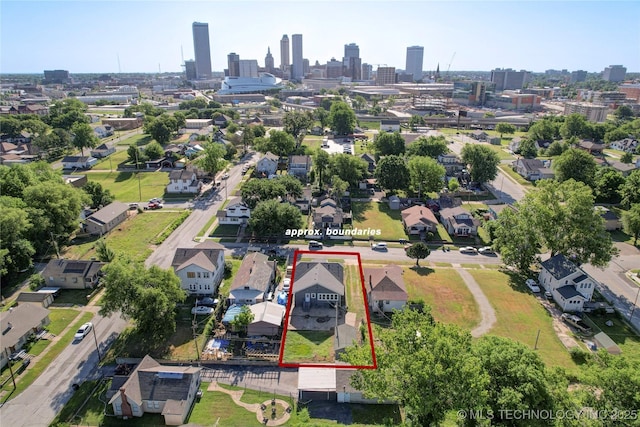 212 S Phoenix Ave, Tulsa, OK 74127 - aerial view of residential area with property boundaries highlighted and city skyline