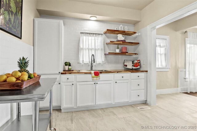 212 S Phoenix Ave, Tulsa, OK 74127 - kitchen featuring butcher block counters, white cabinets, backsplash, and open shelves