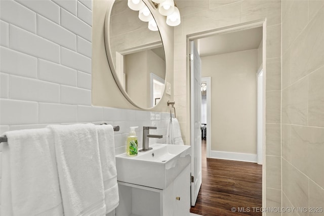 212 S Phoenix Ave, Tulsa, OK 74127 - bathroom featuring tile walls, vanity, and wood finished floors