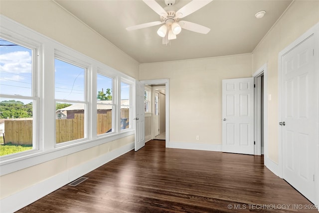 212 S Phoenix Ave, Tulsa, OK 74127 - empty room with healthy amount of natural light, dark wood-type flooring, ceiling fan, and a smoke detector