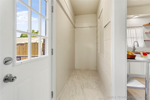 212 S Phoenix Ave, Tulsa, OK 74127 - corridor featuring light marble finish flooring and a sink