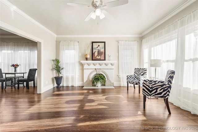 212 S Phoenix Ave, Tulsa, OK 74127 - sitting room featuring healthy amount of natural light, ceiling fan, wood finished floors, ornamental molding, and a brick fireplace