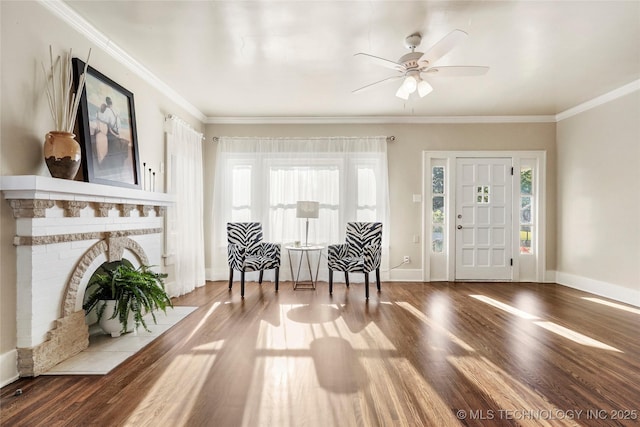 212 S Phoenix Ave, Tulsa, OK 74127 - foyer featuring wood finished floors, ceiling fan, ornamental molding, and a brick fireplace