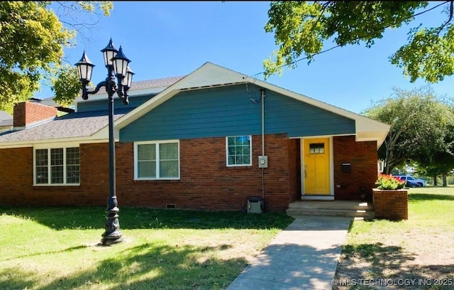 610 W Delaware St, Tahlequah, OK 74464 - view of front facade with a front lawn, brick siding, and crawl space