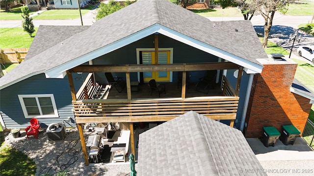 610 W Delaware St, Tahlequah, OK 74464 - back of house featuring roof with shingles