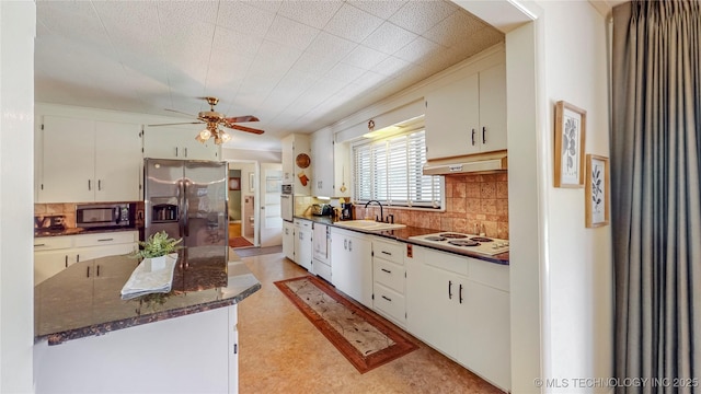 4040 E 46th Pl, Tulsa, OK 74135 - kitchen with stainless steel appliances, under cabinet range hood, backsplash, ceiling fan, and white cabinetry