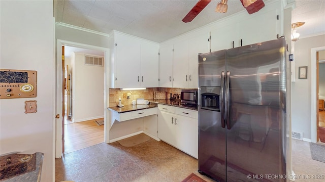 4040 E 46th Pl, Tulsa, OK 74135 - kitchen featuring stainless steel appliances, ornamental molding, dark countertops, decorative backsplash, and white cabinets