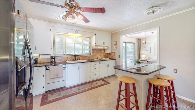 4040 E 46th Pl, Tulsa, OK 74135 - kitchen with stainless steel refrigerator with ice dispenser, dishwasher, dark countertops, ornamental molding, and a kitchen breakfast bar