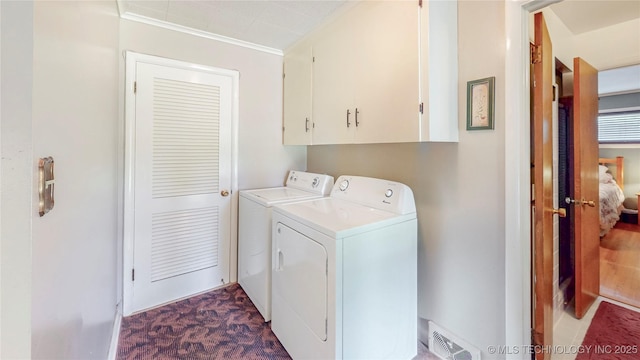 4040 E 46th Pl, Tulsa, OK 74135 - washroom with separate washer and dryer, cabinet space, crown molding, and dark carpet