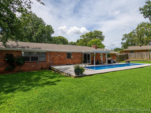 1726 Harned Dr, Bartlesville, OK 74006 - rear view of property with a chimney, brick siding, and a patio