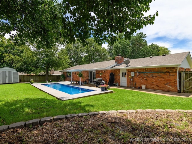 1726 Harned Dr, Bartlesville, OK 74006 - rear view of property featuring a shed, brick siding, a fenced backyard, a chimney, and a patio