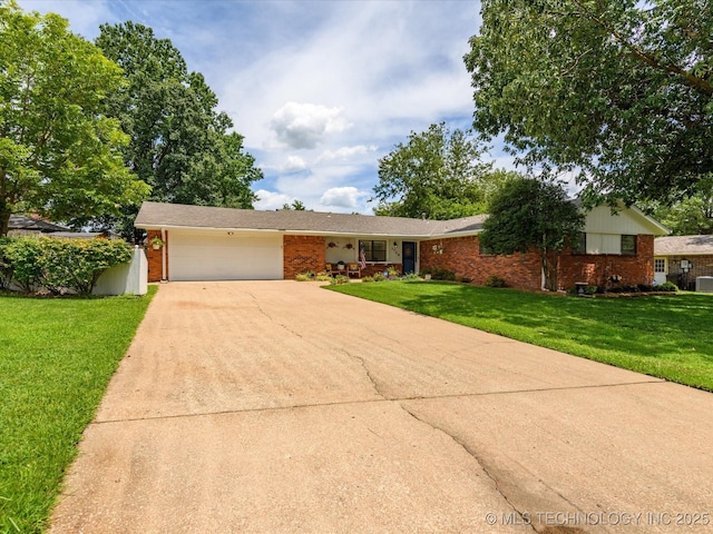 1726 Harned Dr, Bartlesville, OK 74006 - ranch-style home featuring brick siding, an attached garage, a front yard, and driveway