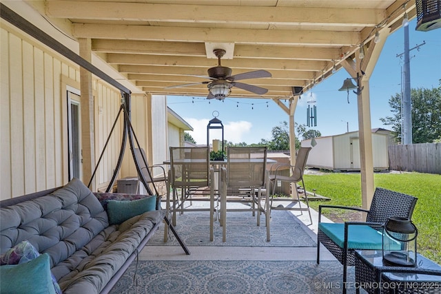 8736 E 59th St, Tulsa, OK 74145 - view of patio / terrace featuring outdoor dining area, a ceiling fan, a storage unit, and an outdoor hangout area