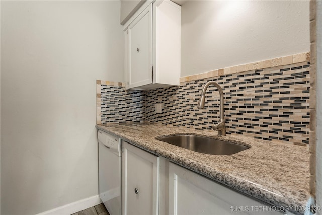 4660 E 68th St Unit 179, Tulsa, OK 74136 - kitchen with dishwasher, backsplash, white cabinets, and light stone counters